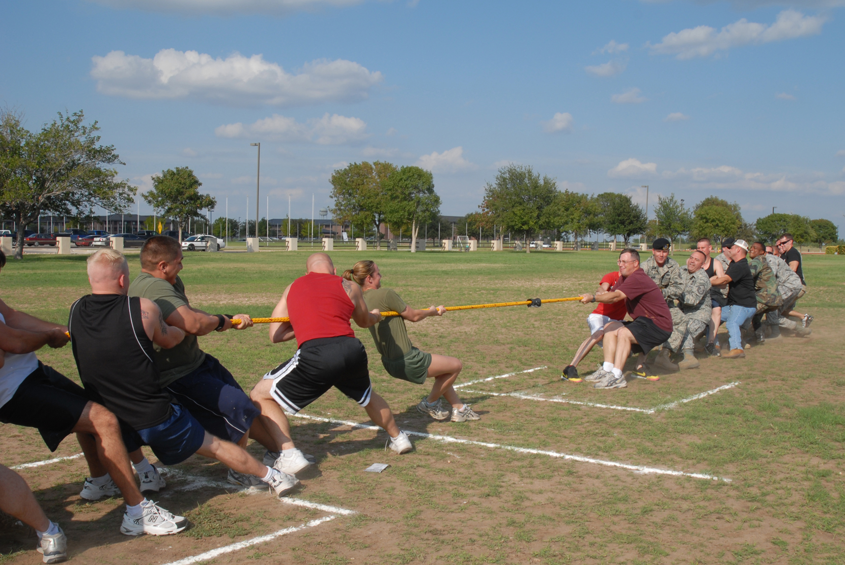 Marines and Airmen at Goodfellow Air Force Base competing in a tug of war.