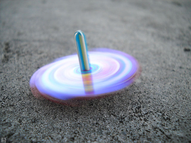 In image of a spinning top demonstrates rotary motion.